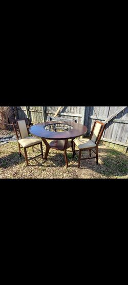 Ashley Furniture  Dinning Room Table Wood With  Glass Center And Carving With Shelves Below  Comes With W/ 4 Chairs  White/off-white Colored Seating 