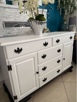 Solid wood buffet cabinet with drawers and shelves 54” long 20” wide and 35” high in good condition