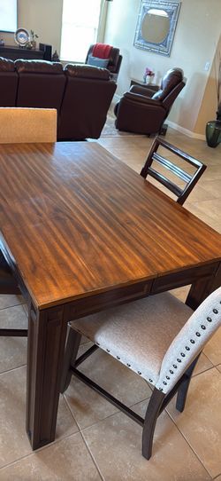 Counter‑height 9‑piece dining set with hidden leaf & stools