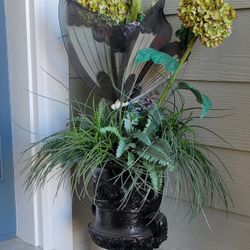Planter with artificial flower arrangement