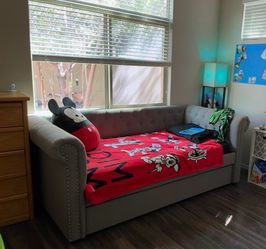 Upholstered day bed with trundle