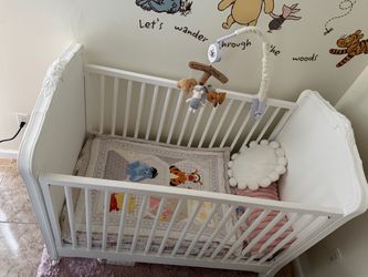 White Wood Baby Crib with Floral Detail