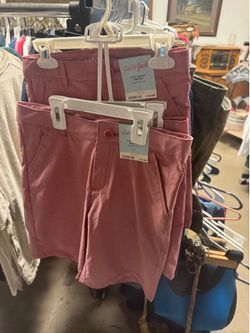Boys shorts Cat & Jack brand boys' pink flat-front chino shorts featuring an adjustable waist and priced at $15.00. 3 pairs left 2 size 7 1 size 12