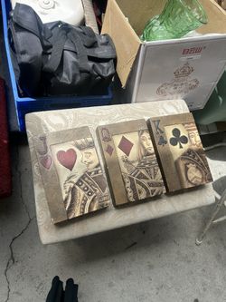 decorative 3D wall sculptures modeled after playing cards, specifically the Jack of Hearts, Queen of Diamonds, and King of Clubs.