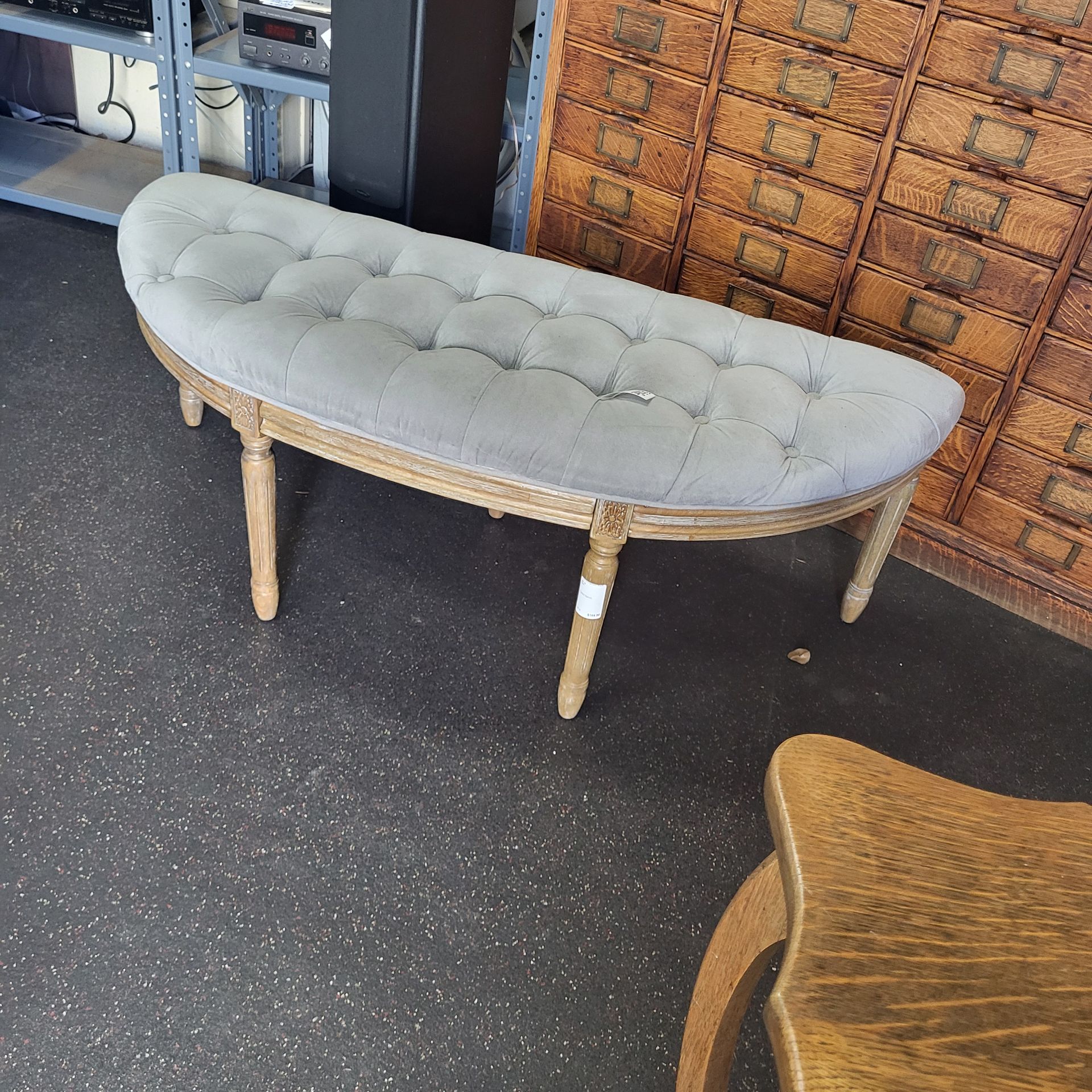 curved tufted bench or a half-moon ottoman
