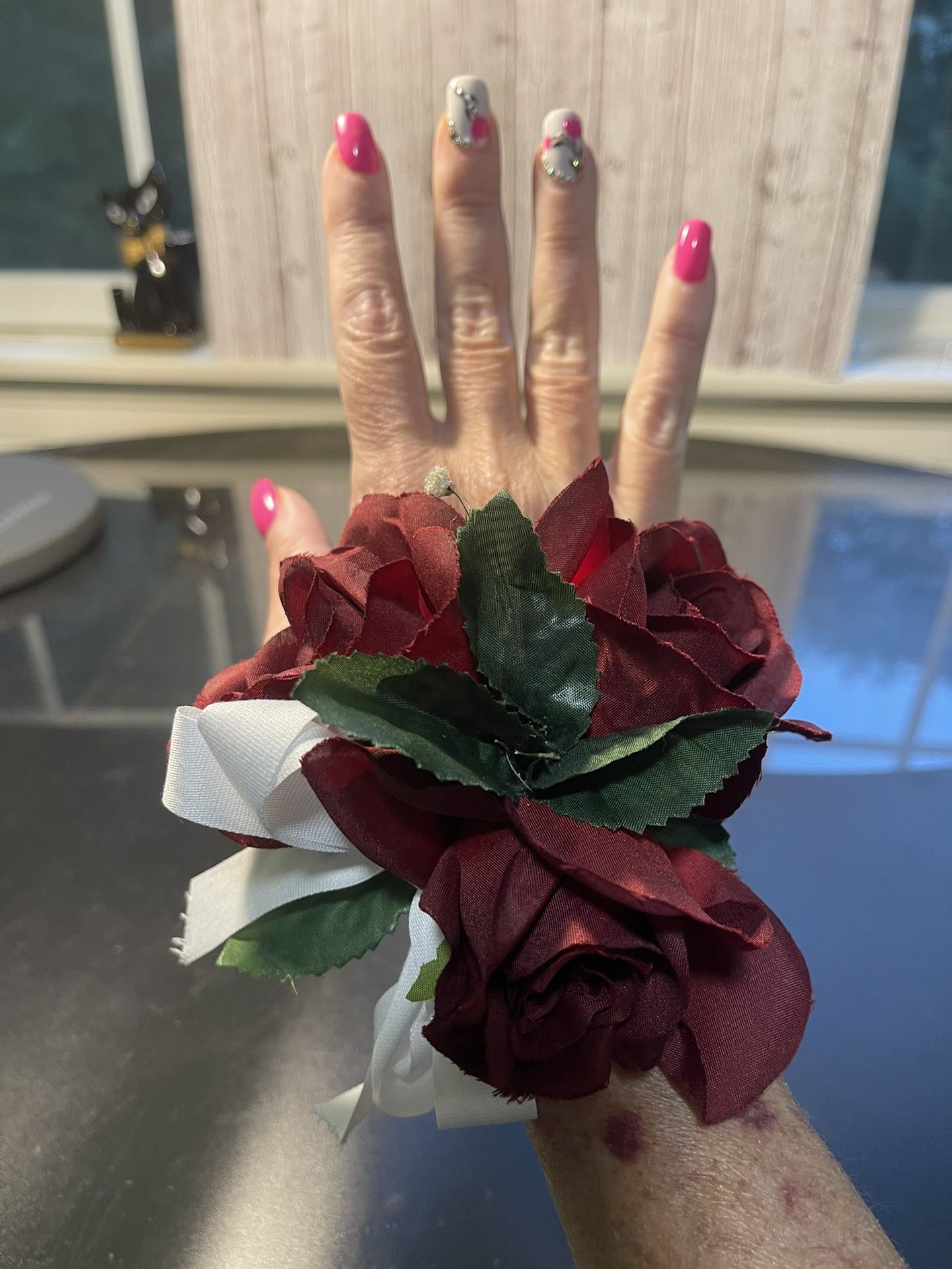 Handmade Corsage Wristlet Burgundy Roses Green Leaves Gorgeous corsage, lifelike roses, great color combo Has an interesting feature one small dried f