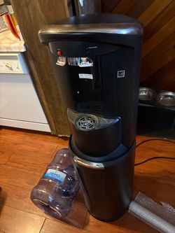 Bottom load water dispenser and three, 5 gallon water jugs.