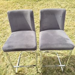 2 gray suede bar stools for sale.