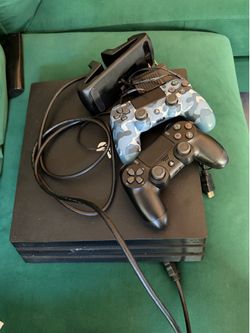 PS4 Pro console with 2 controllers and charging dock