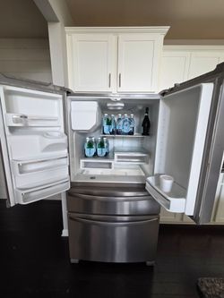 White Front-Load DryerWhirlpool 4-Door Refrigerator & LG Steam Front-Load Washer/Dryer Set