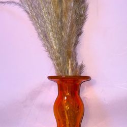  unique decanter is a vibrant orange color and a crystal top