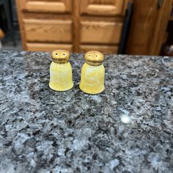 Ceramic Vintage Small Yellow and Gold Color Pair of salt and pepper shakers.  Size approximately  1 1/2 inches tall.  Preowned good condition. 