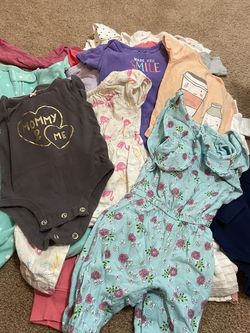 Baby girl clothes pile