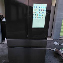Samsung brand 4-door refrigerator has a screen that is 36 wide by 68.5 high and 24 deep