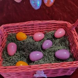 Colorful Easter eggs and basket with bunnies on it.