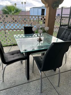 Dining table with four leather chairs.