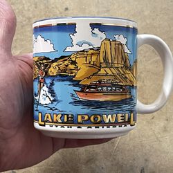 vintage ceramic mug is a souvenir featuring a detailed illustration of Lake Powell in Utah and Arizona.  It depicts a scenic landscape with rock forma