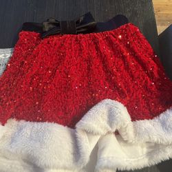 Red sequin Santa skirt with white fur trim and black bow. Size: M 