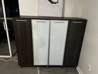 Four-door buffet storage cabinet with a walnut finish and frosted glass accents