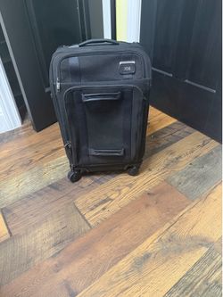 Matching Tumi carry on suitcase and briefcase