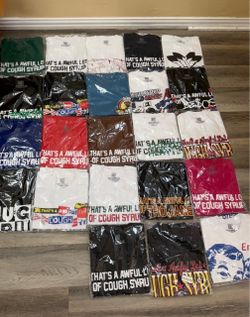 That's an "Awful Lotta Cough Syrup" graphic t-shirt featuring a stylized print design