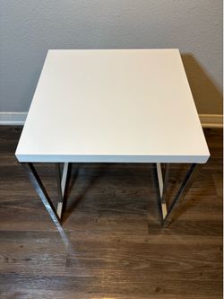 Small White Side Table - The Tabletop is made from engineered wood and plastic with a glossy PVC veneer that reflects the light with a Chrome-finished