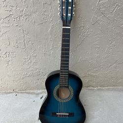 Children's or teenager's guitar. Three iron strings, three plastic. Will teach excellently. Small chips