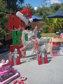 Large snowman three deers and Ho-Ho sign and two present metal signs asking $150 for everything everything works just used
