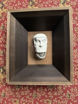 Wawel Heads – A woman with a wimple covering her mouth