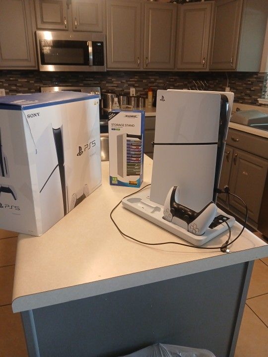 "PS5" WITH GAME STAND.. 2 GAMES "NBA2K25" "THE LAST OF US" ... ONE CONTROLLER.. BRAND NEW STORAGE STAND