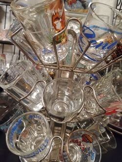 Over 200 collectible shit glasses some in racks