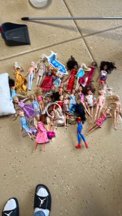 Barbie dolls and a pillow