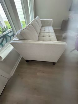 off-white/cream sofa in a modern style.