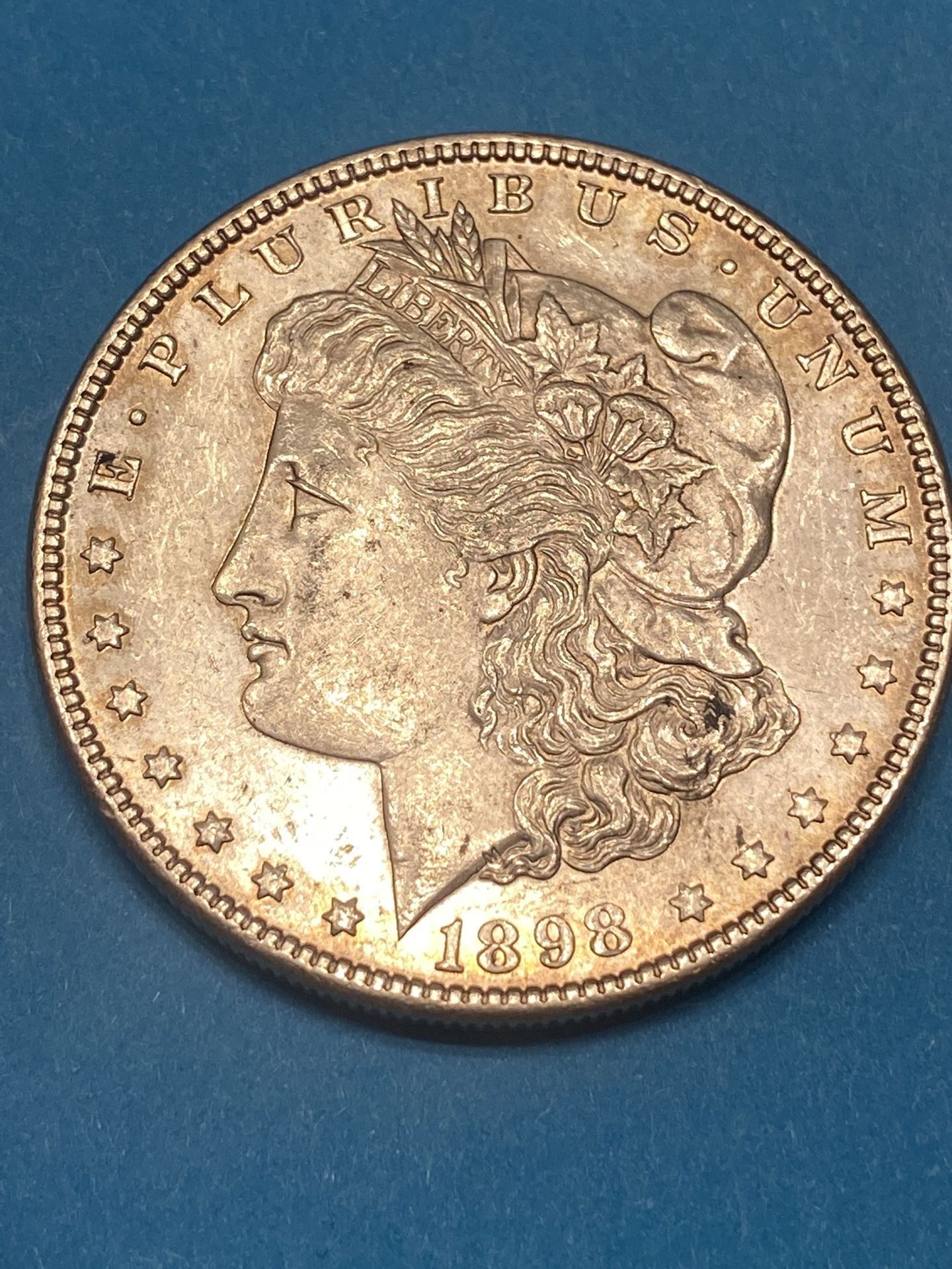 1898-P MORGAN SILVER DOLLAR WITH A PROOF LIKE FIELD ON THE OBVERSE