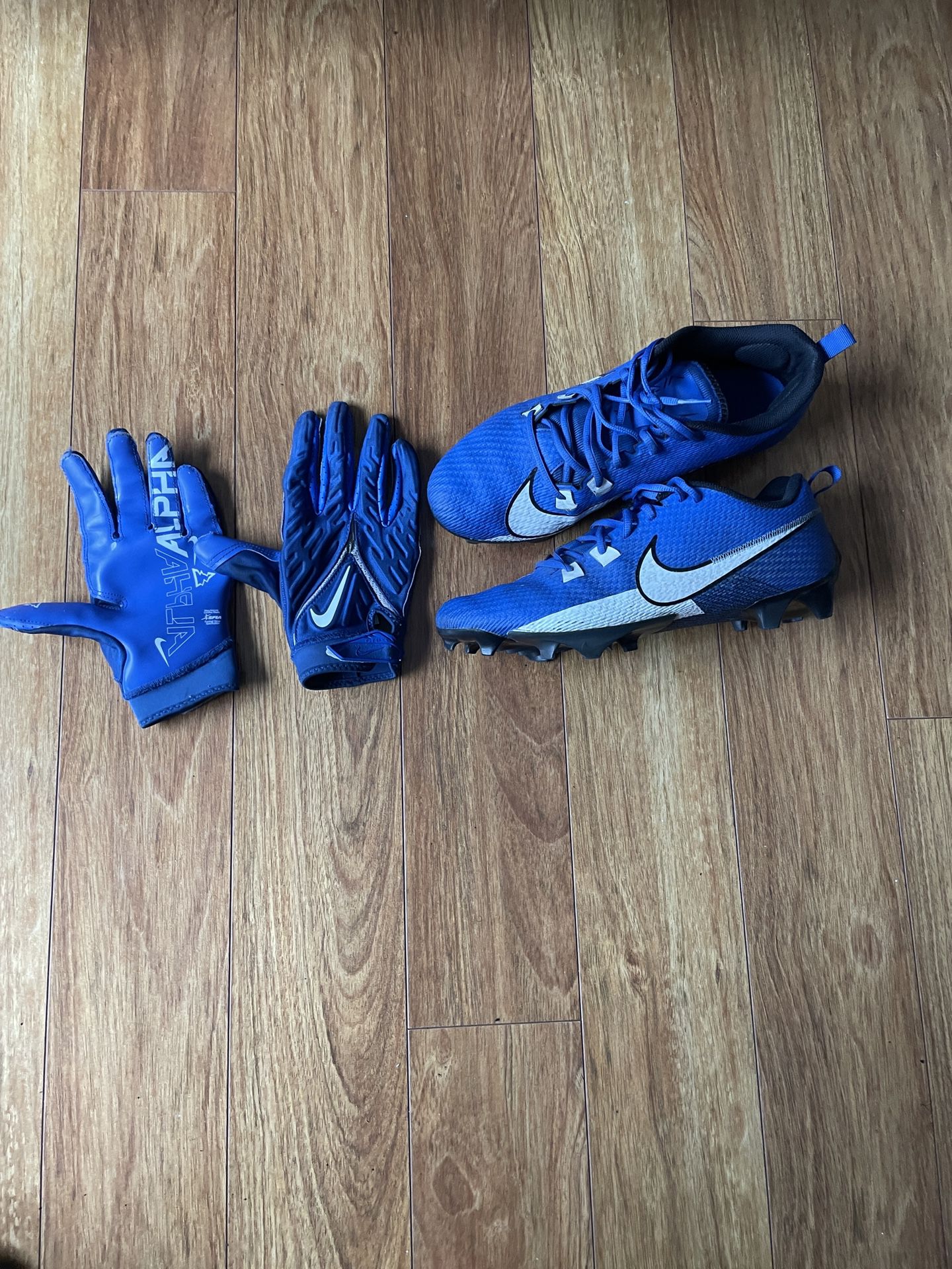 Blue football cleats with blue football gloves