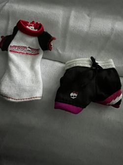 Monster High doll outfit with a white and black top and black shorts. Features red and pink accents.