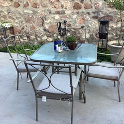 Patio Set 4 Metal Chairs With 4 Comfortable Cushions And A Tempered Glass Table Ready For An Umbrella $185 