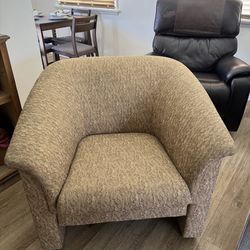 tub-style accent chair featuring a textured, camel-colored boucle fabric and a curved design.