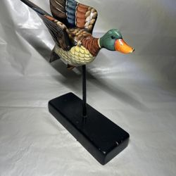 hand-carved and hand-painted wooden mallard duck figurine mounted on a stand