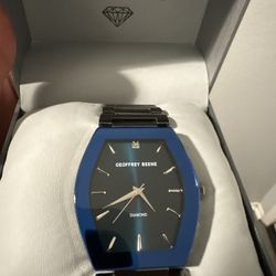 Geoffrey Beene men's tonneau bracelet watch with a genuine diamond accent on the dia