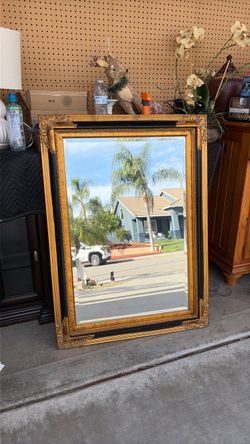 Large black and gold mirror