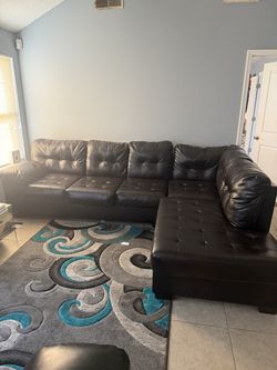 Black leather sectional and love seat