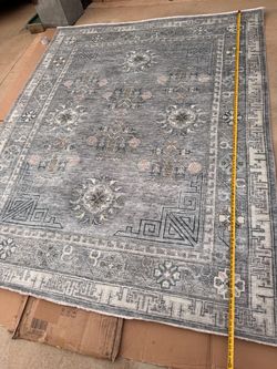 New Area Rug 7’10"X9'10" the soft elegance of a timeworn heirloom, its traditional pattern softly layered in multi-toned grays and blues, with a gentl