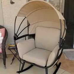 Black Rocking Aluminum Outdoor Lounge Chair with Tan Cushion and Tan Sun Shade Cover