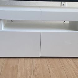 Glossy white TV stand with storage