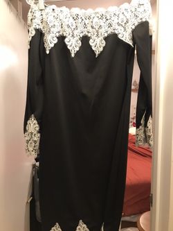 Black strapless dress with lace on top and bottom of the dress.