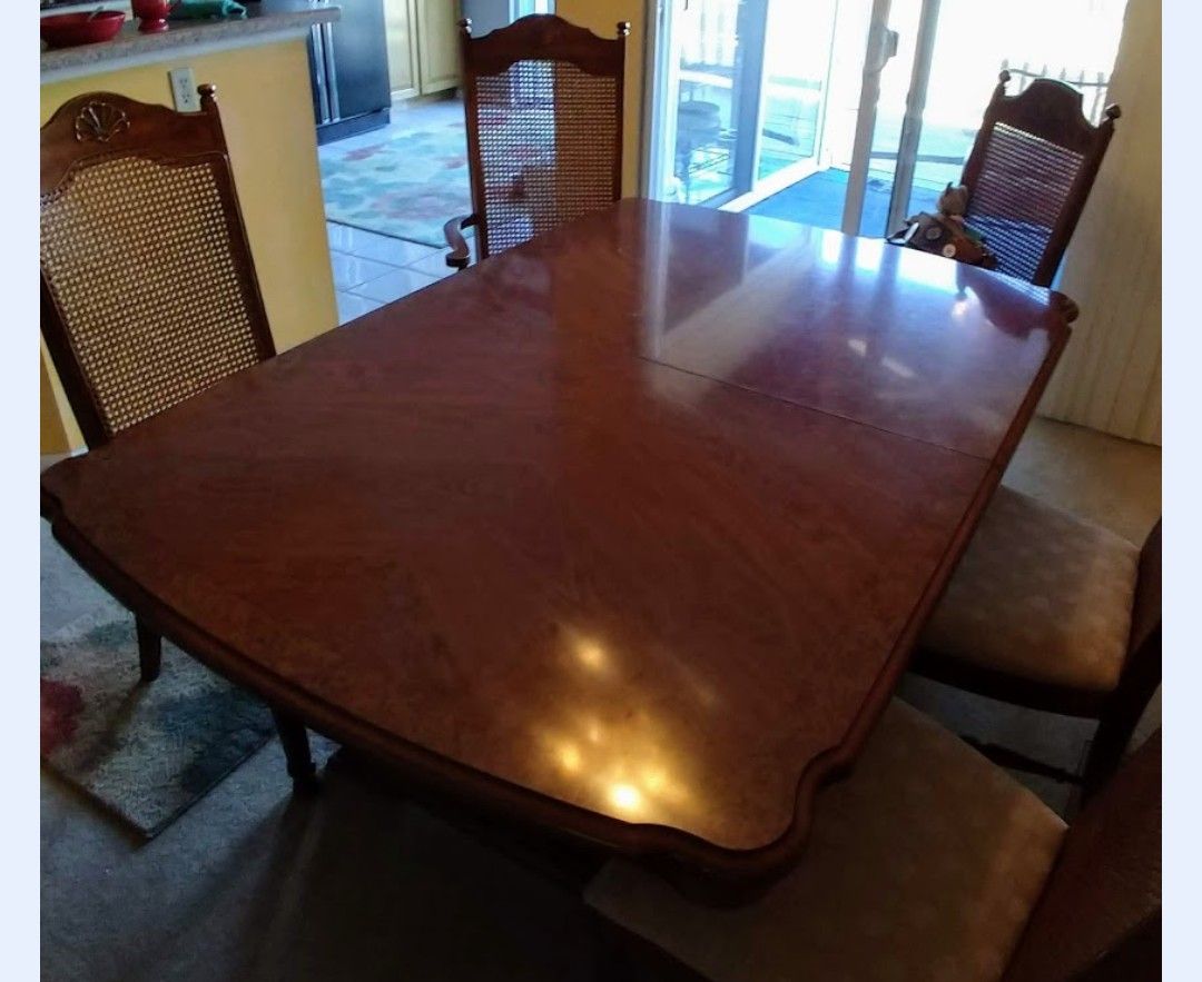 Two dining room tables with four chairs each