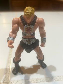 a 2003 Mattel Masters of the Universe He-Man action figure, released as a promotional toy in McDonald's Happy Meals. The figure stands roughly 4 to 4.