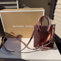 Michael Kors Mercer Extra-Small Metallic Leather Crossbody Bag in a primrose or rose gold tone 
