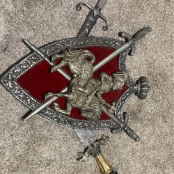 2 Daggers And A Iron Shield Wall Plaque